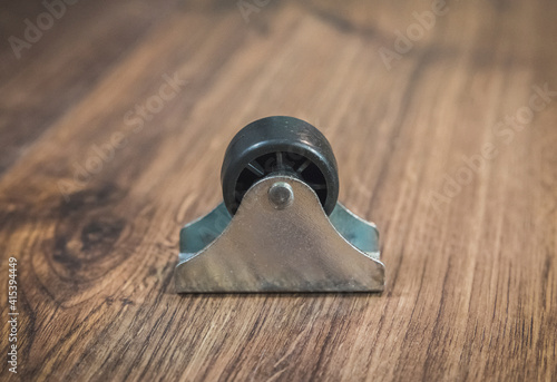 black plastic wheel which will attached to the furniture photo