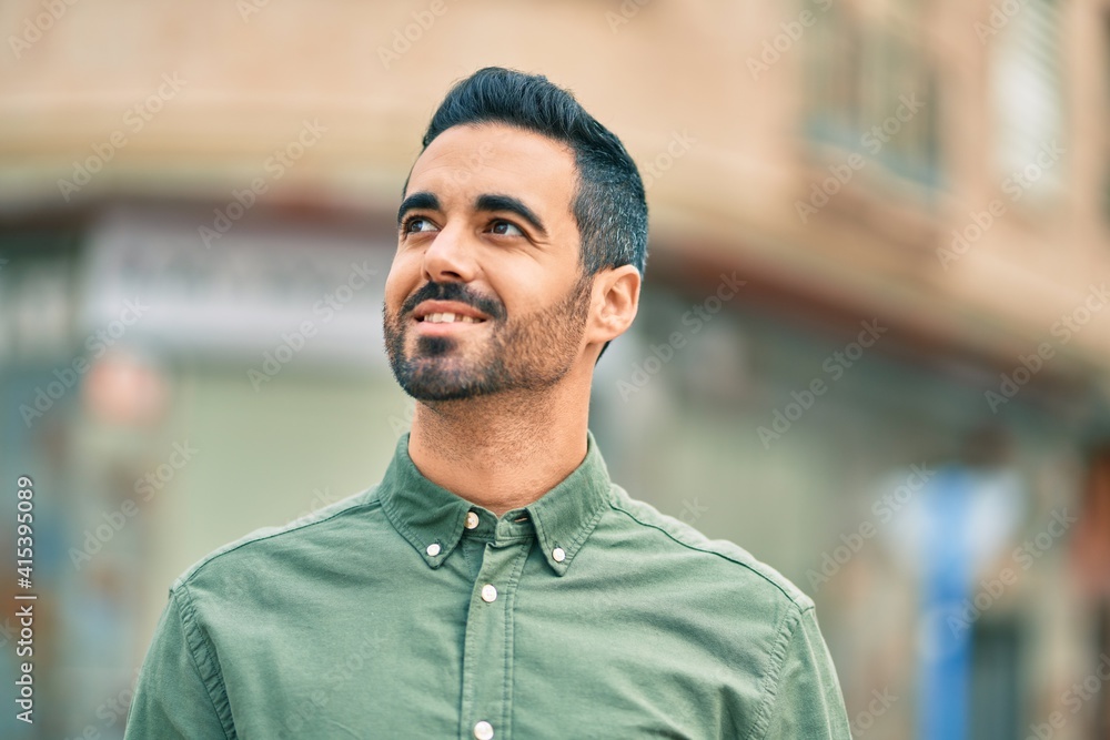 Young hispanic man smiling happy standing at the city. Young hispanic man smiling happy standing at the city.