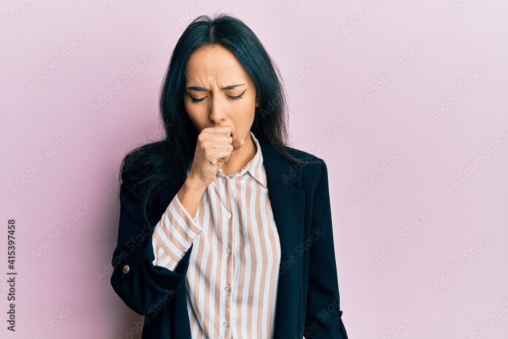 Young hispanic girl wearing business clothes feeling unwell and coughing as symptom for cold or bronchitis. health care concept. Young hispanic girl wearing business clothes feeling unwell and coughing as symptom for cold or bronchitis. health care concept.