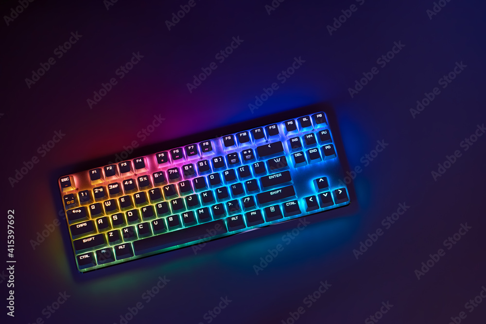 Gaming keyboard with RGB light. White mechanical keyboard. Gamer's workspace, neon light. - obrazy, fototapety, plakaty 