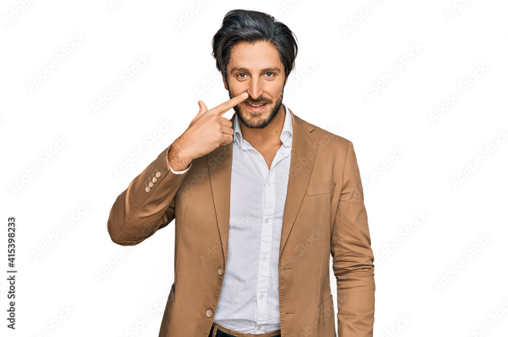 Young hispanic man wearing business clothes pointing with hand finger to face and nose, smiling cheerful. beauty concept Young hispanic man wearing business clothes pointing with hand finger to face and nose, smiling cheerful. beauty concept