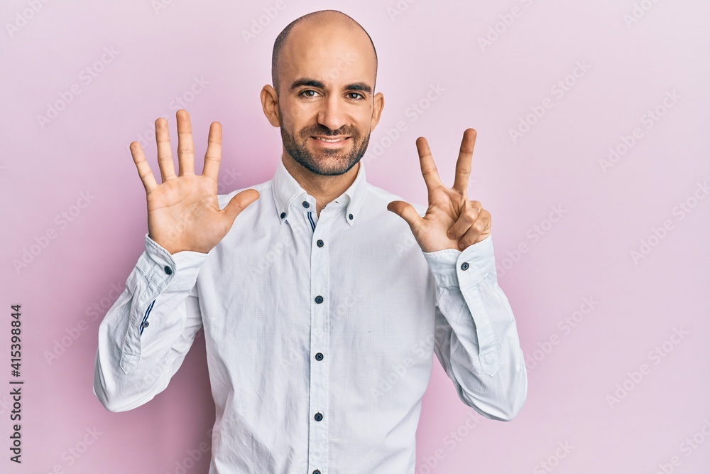 Young hispanic man wearing casual clothes showing and pointing up with fingers number eight while smiling confident and happy. Young hispanic man wearing casual clothes showing and pointing up with fingers number eight while smiling confident and happy.