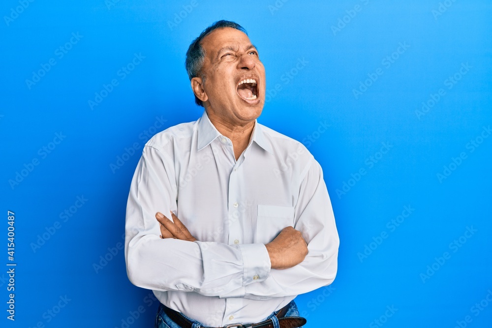Middle age indian man with arms crossed gesture angry and mad screaming frustrated and furious, shouting with anger looking up. Middle age indian man with arms crossed gesture angry and mad screaming frustrated and furious, shouting with anger looking up.
