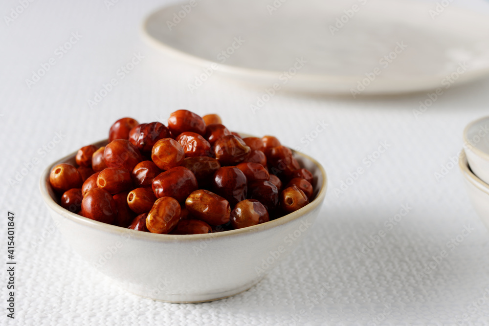 Dried bolivian chili peppers in white bowl close-up. Dried bolivian chili peppers in white bowl close-up.