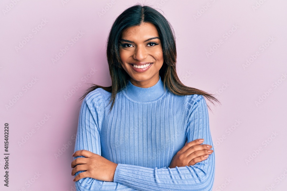 Young latin transsexual transgender woman wearing casual clothes happy face smiling with crossed arms looking at the camera. positive person. Young latin transsexual transgender woman wearing casual clothes happy face smiling with crossed arms looking at the camera. positive person.