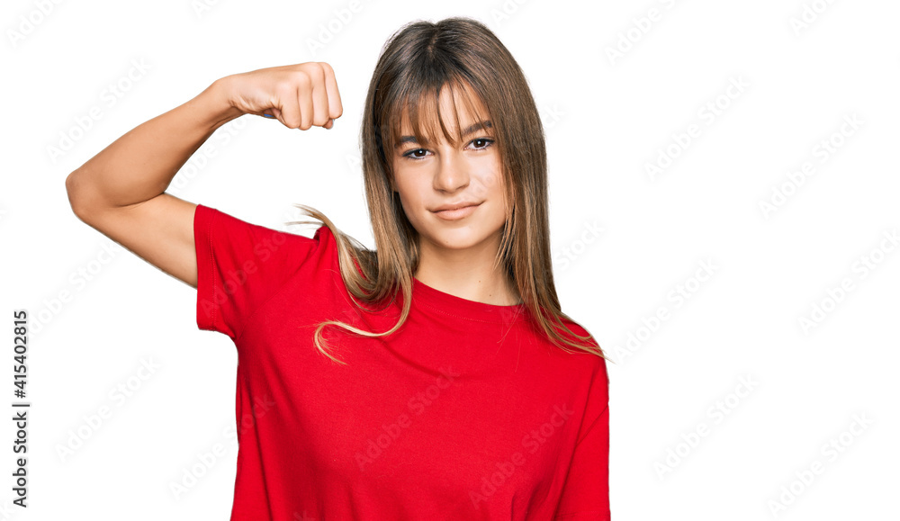 Teenager caucasian girl wearing casual red t shirt strong person showing arm muscle, confident and proud of power Teenager caucasian girl wearing casual red t shirt strong person showing arm muscle, confident and proud of power