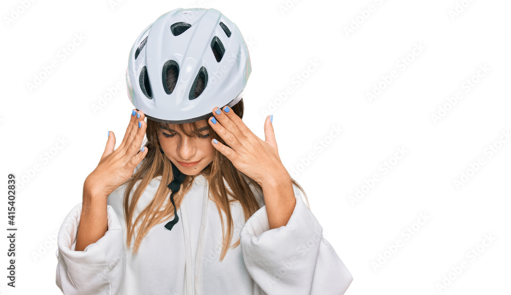 Teenager caucasian girl wearing bike helmet with hand on head for pain in head because stress. suffering migraine. Teenager caucasian girl wearing bike helmet with hand on head for pain in head because stress. suffering migraine.