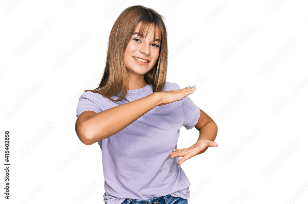 Teenager caucasian girl wearing casual clothes gesturing with hands showing big and large size sign, measure symbol. smiling looking at the camera. measuring concept. Teenager caucasian girl wearing casual clothes gesturing with hands showing big and large size sign, measure symbol. smiling looking at the camera. measuring concept.