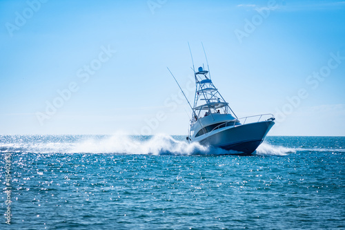 Sportfishing boat with a wake cruising in the open water
