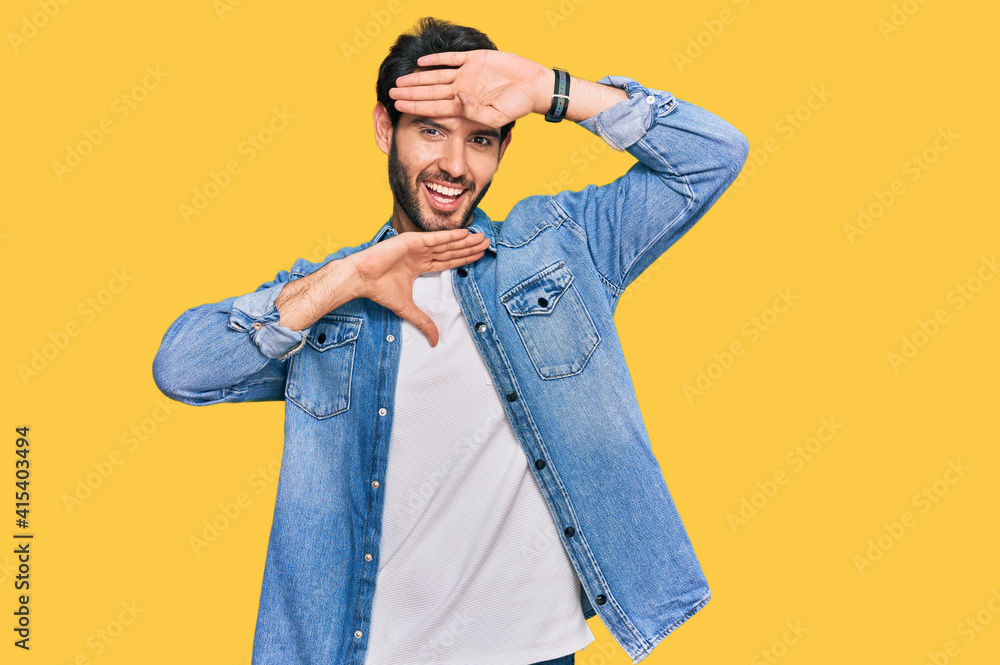 Young hispanic man wearing casual clothes smiling cheerful playing peek a boo with hands showing face. surprised and exited Young hispanic man wearing casual clothes smiling cheerful playing peek a boo with hands showing face. surprised and exited