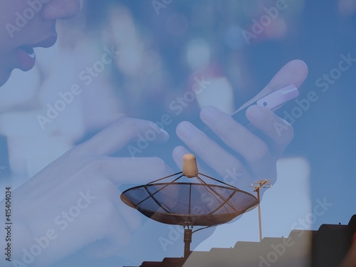 The black satellite dish on the roof in the sunlight has a hand-held picture overlaid. photo