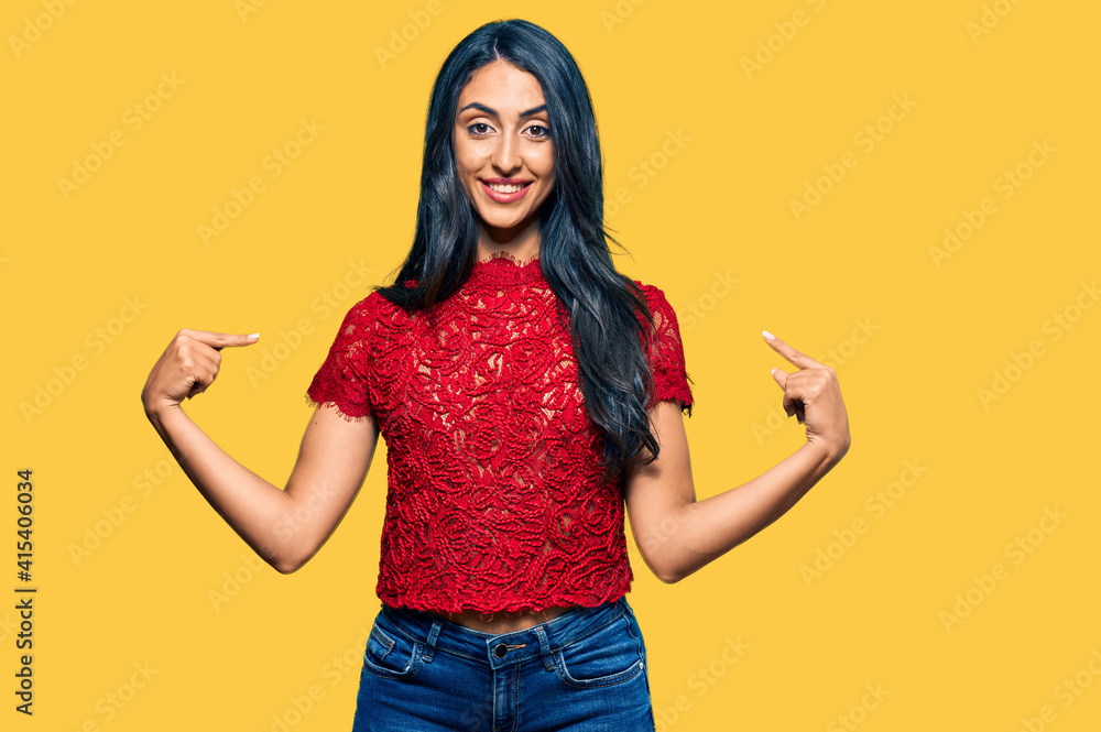 Beautiful hispanic woman wearing elegant shirt looking confident with smile on face, pointing oneself with fingers proud and happy. Beautiful hispanic woman wearing elegant shirt looking confident with smile on face, pointing oneself with fingers proud and happy.