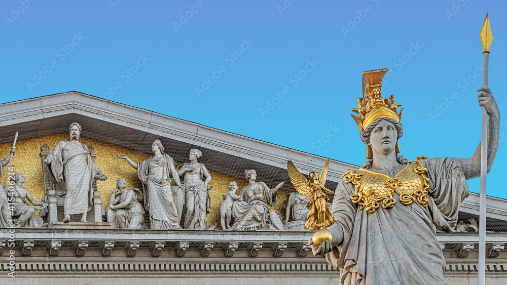 Obraz premium Athena statue at fountain (Pallas-Athene-Brunnen) in front of the Parliament, an ancient Greek goddess for victory and warfare at blue sky in Vienna, Austria, details, closeup.