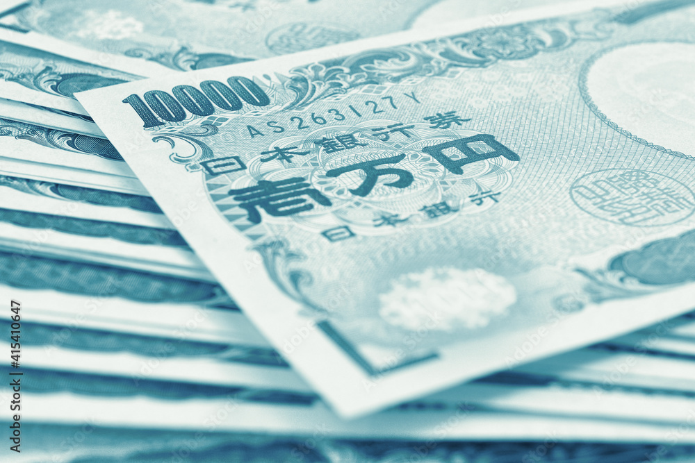 Obraz premium Light background on the theme of Japanese money, finance and economy. Blue green tinted backdrop. Yen banknotes close up. Blurred with focus on 10,000. Banking, savings, deposit and loan. Macro