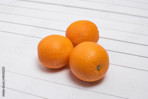 oranges on white wooden background