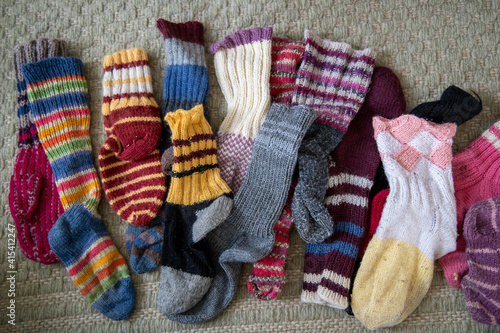 many colorful wool socks on a carpet