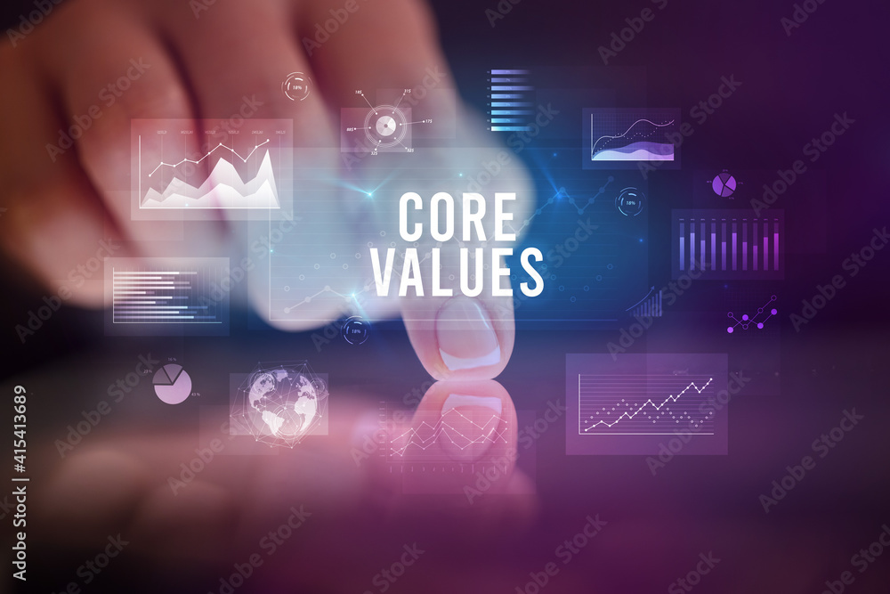 Finger touching tablet with charts and CORE VALUES inscription, business concept Finger touching tablet with charts and CORE VALUES inscription, business concept