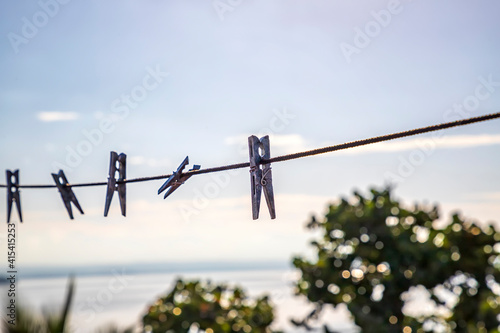 Clothespins holding clothes in laundry. clothespin on a string in a balcony. Abstract view