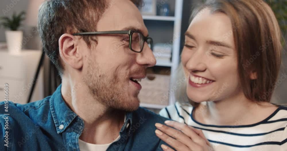 Close up of beautiful young couple recording video messages for friends and relatives on social networks. View from camera. Close up of beautiful young couple recording video messages for friends and relatives on social networks. View from camera.