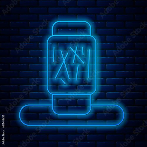Glowing neon line Cat scratching post with toy icon isolated on brick wall background. Vector.
