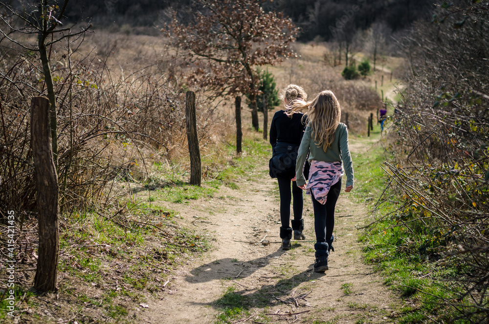 two children walking together free in the nature