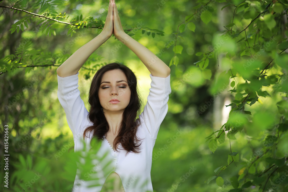 Pregnant woman doing yoga exercise in nature on a summer Pregnant woman doing yoga exercise in nature on a summer