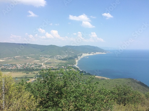 view of mountains, sea and clouds on a clear day