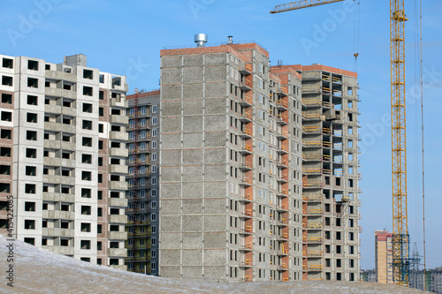 Construction crane next to a building under construction. City construction. Building construction