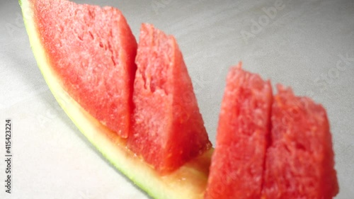 4K panning organic red watermelon and slice isolated on granitte background photo