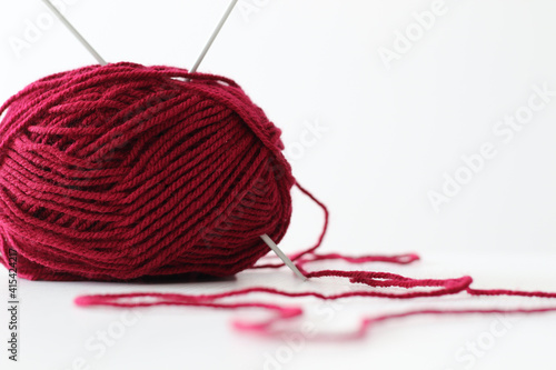 ball or red wool yarn and knitting needles