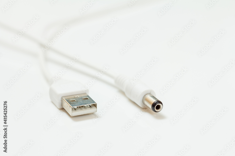USB cable in white color on a white background USB cable in white color on a white background