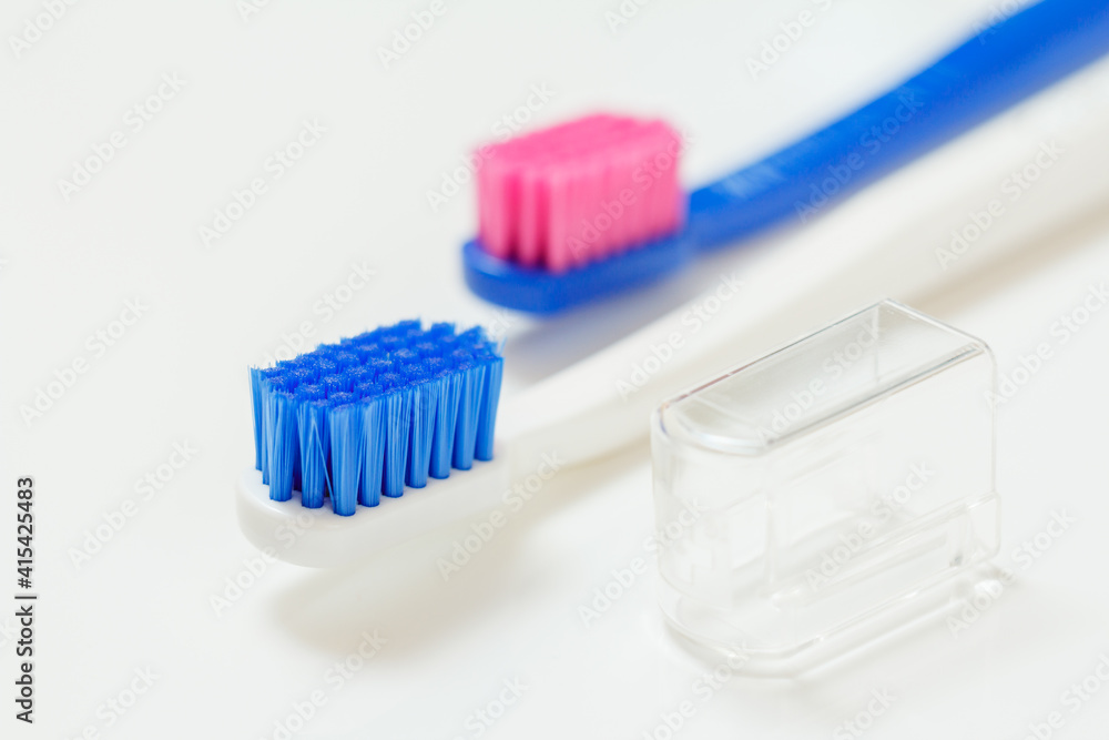White and blue toothbrushes on the white background. White and blue toothbrushes on the white background.