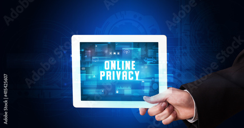 Wallpaper Mural Young business person working on tablet and shows the digital sign: ONLINE PRIVACY Torontodigital.ca