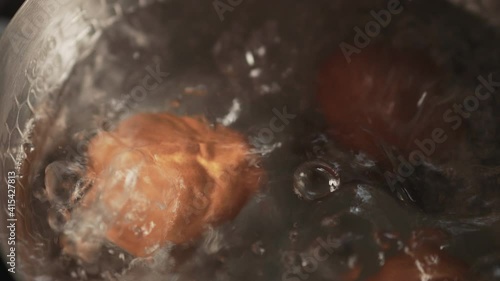 4k Motion of Egg Boiling in the Pot. Boiled Eggs on Hot Water and Steam. Closeup shot