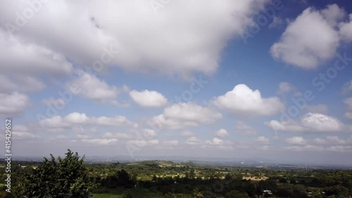 Conntryside Scenery Landscape. Time Lapse 4k Motion of White Clouds on Blue Sky background. Weather and Environment in Summer, Spring Season concept