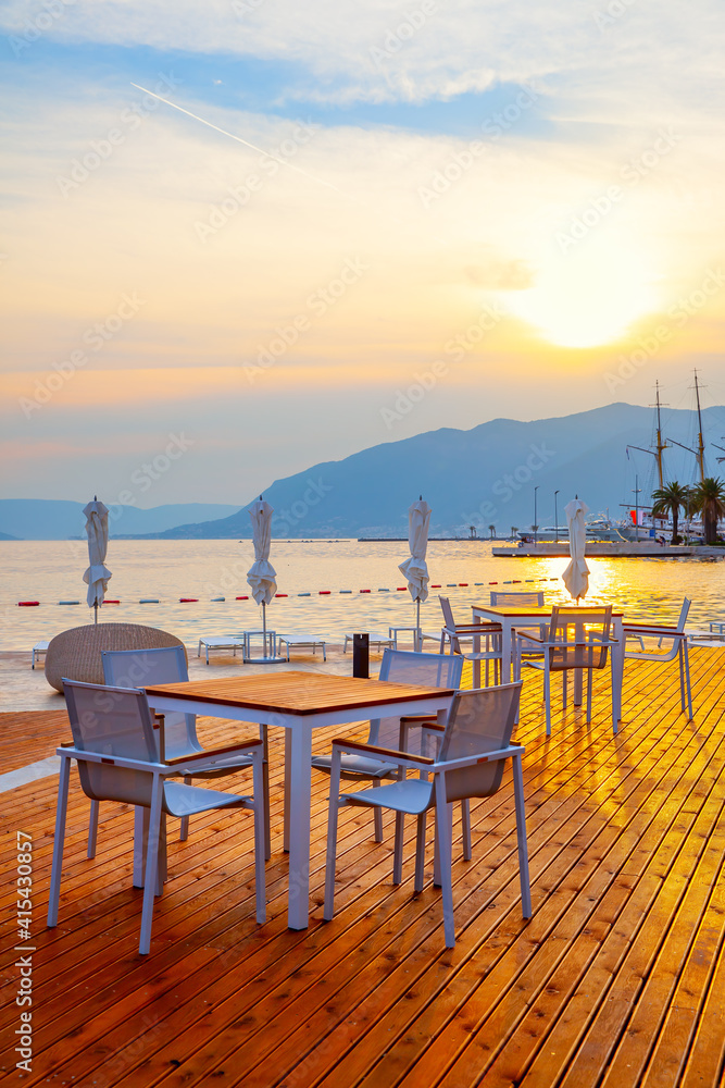 Open air cafe near the sea at sunset