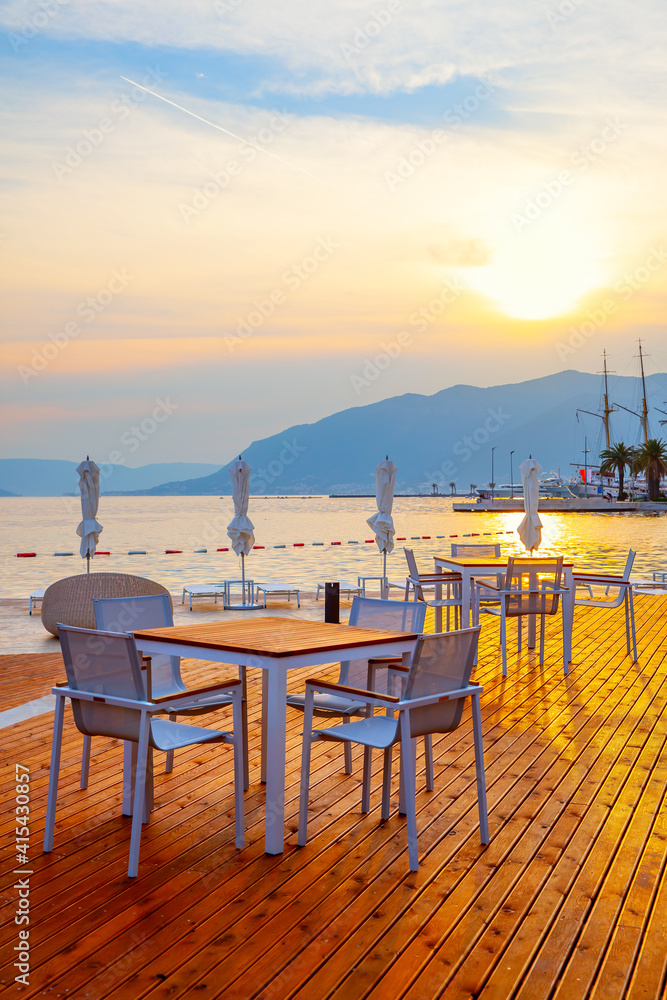 Open air cafe near the sea at sunset Open air cafe near the sea at sunset