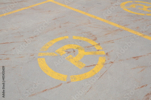 yellow no parking sign or symbol on the ground