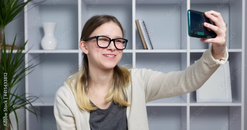 The girl is talking looks into the smartphone. Online webinar using your phone's webcam. The girl is talking looks into the smartphone. Online webinar using your phone's webcam.