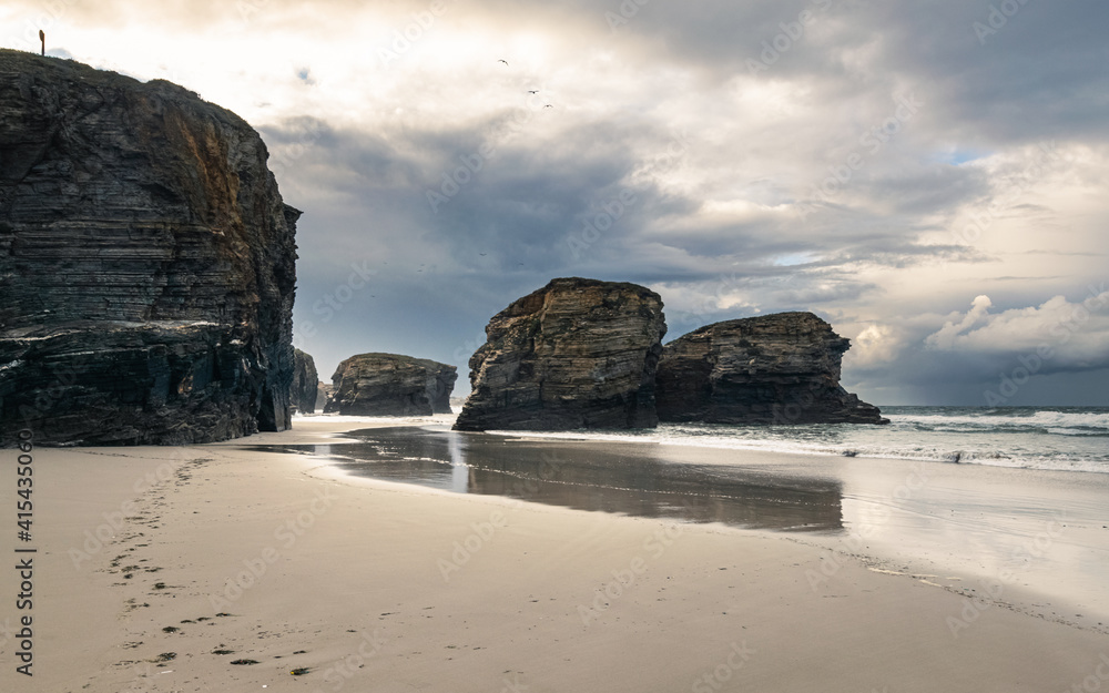 Scenic Playa de las Catedrales (Beach of the Cathedrals) featuring stunning rock arches, during low tide.