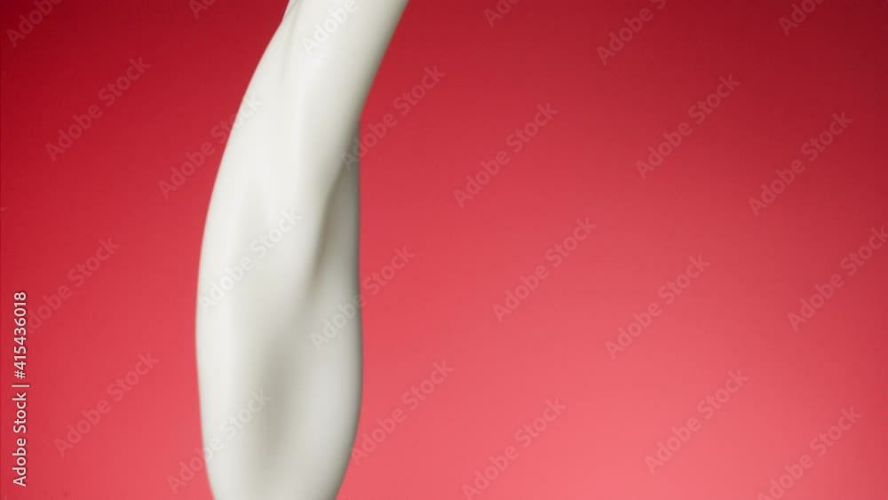 Macro shot of milk stream falling in slow motion Macro shot of milk stream falling in slow motion