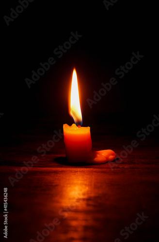 light candle burning brightly,Candle light close up on black background. Burning candle. Candle Flame.
