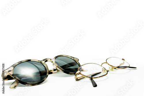 gold eyeglasses and modern sunglasses. isolated