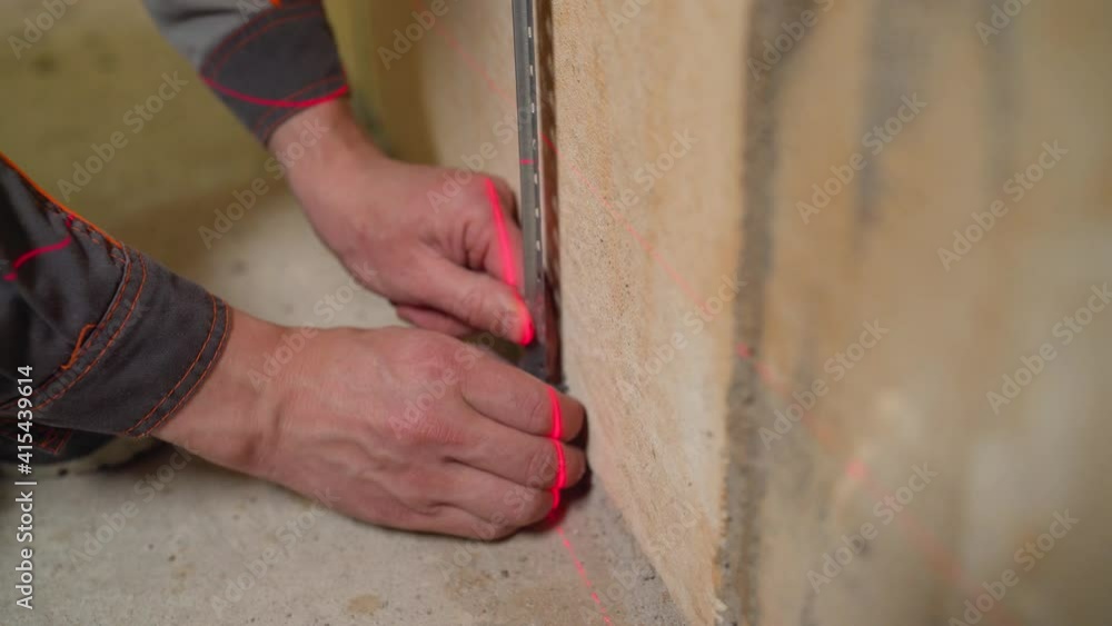 Construction work in the room. Installation of metal beacons to level ...