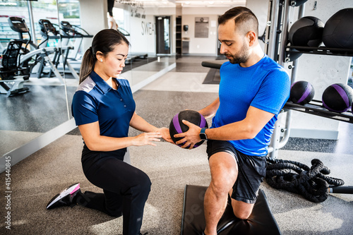 Physiotherapist working with client on rehabilitation exercises