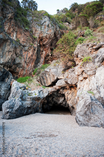 The typical cavernous rocks and maquis along the Cilento coast. Salerno, Italy, Europe.