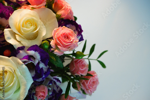 Background. Bouquet of flowers close-up on a white background. White and pink roses  blue-white eustoma. Place for text.