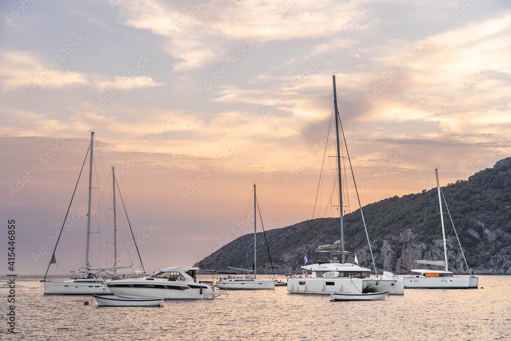 Boats and yachts on adriatic sea in Komiza on vis island in Croatia sunset