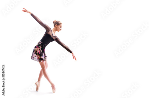 Ballerina in black pointes posing in graceful pose on white background