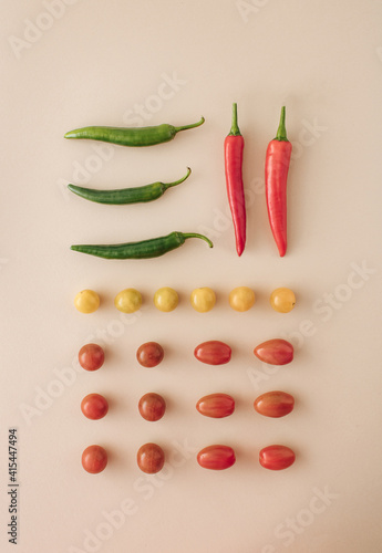 Fresh jucy vegetables. Fresh  chilli, fresh tomato various shapes. red, green, orange. Healthy food. Healty cusine. Minimal flat lay concept against pastel background.
